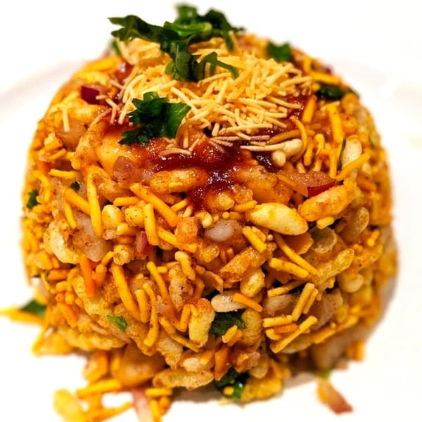A close-up of Jalsa's Bhel Puri, a vibrant Indian snack with puffed rice, chutneys, and sev.